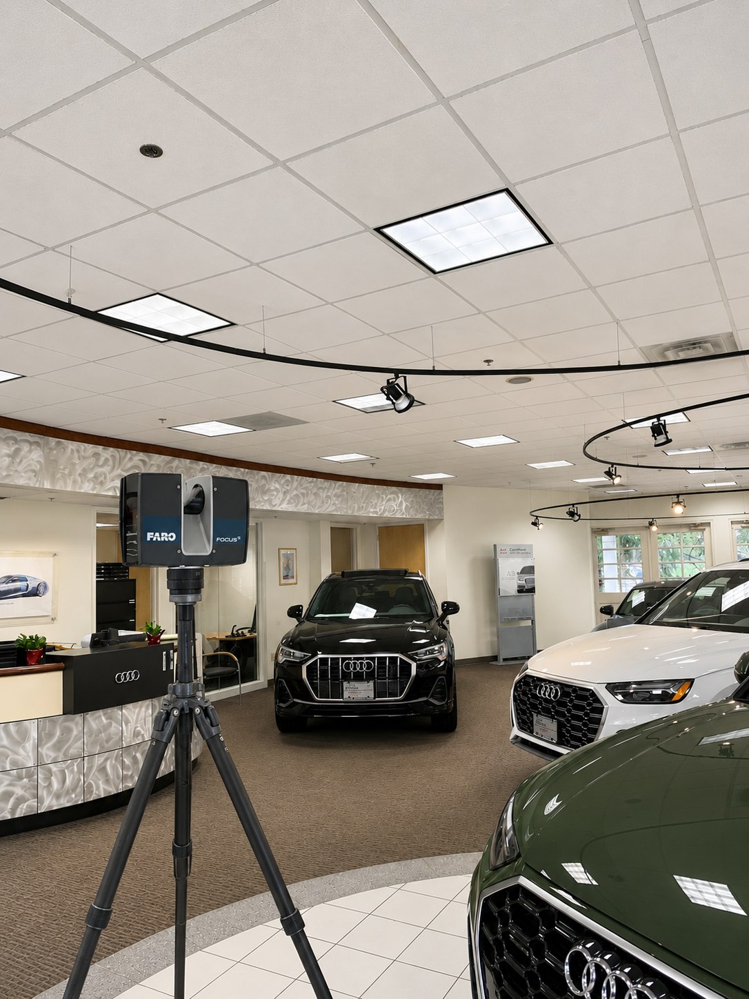 FARO laser scanner scanning the Audi of Mendham showroom floor between new Audi vehicles