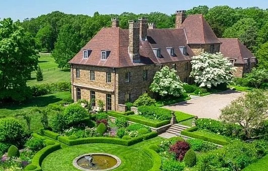 Aerial view of the Ellistan Estate stone manor in Peapack-Gladstone, NJ, with formal gardens and fountain