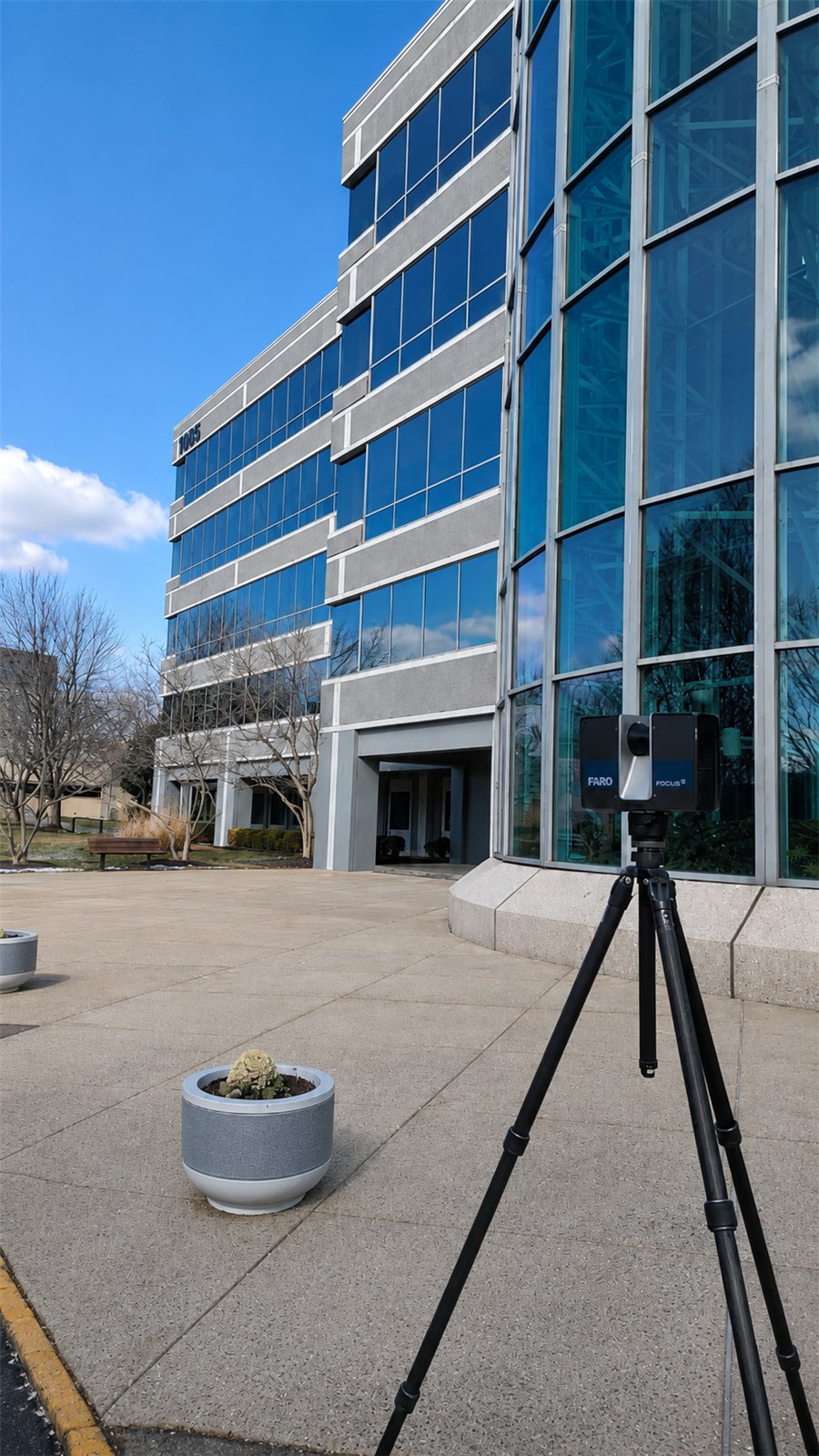 FARO laser scanner on a tripod beside the curved glass rotunda of the Kean University building at 1085 Morris Avenue, Union NJ