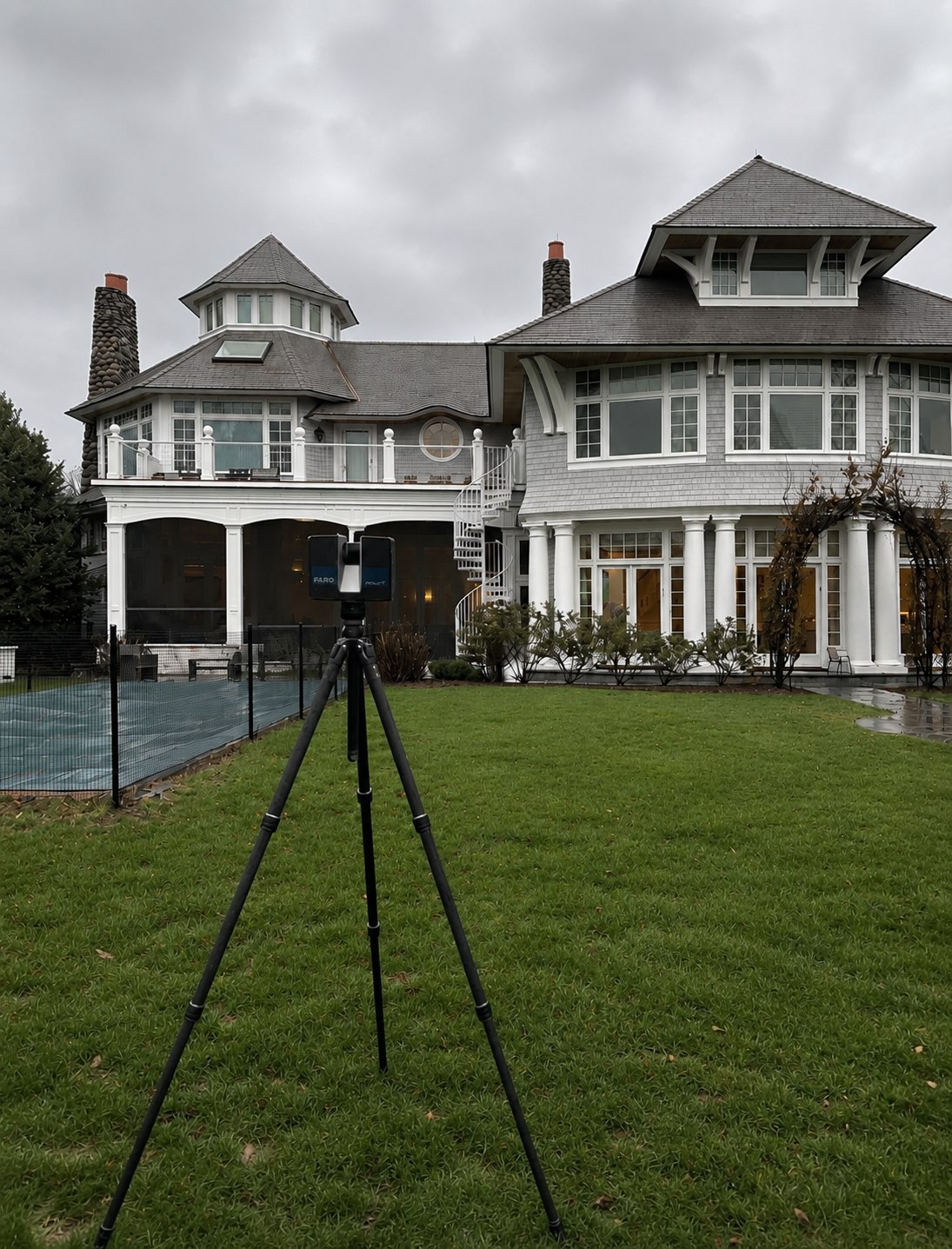 FARO laser scanner on a tripod on the rear lawn of a shingle-style private estate in Connecticut